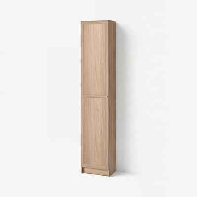 A tall, light brown BILLY bookcase. It has a simple, rectangular shape with one closed door. The wood grain finish adds a natural touch.