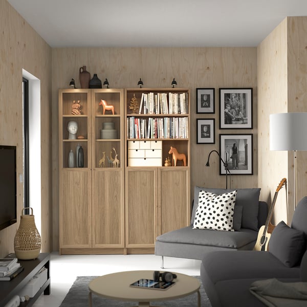 Living room with BILLY bookcases, grey sofa, and round coffee table.