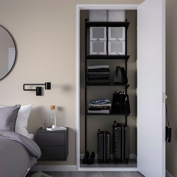 Modern bedroom with black BOAXEL storage unit, open shelves, and minimalist decor.
