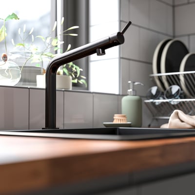 Black BOSJÖN kitchen faucet with smooth curves and sleek, stainless steel finish stands out in kitchenware.