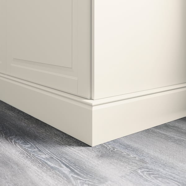 White cabinet base with plinth covering floor gap, part of kitchen decor.