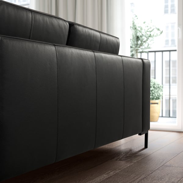 Modern black leather sofa, sleek design, fits well in large rooms.