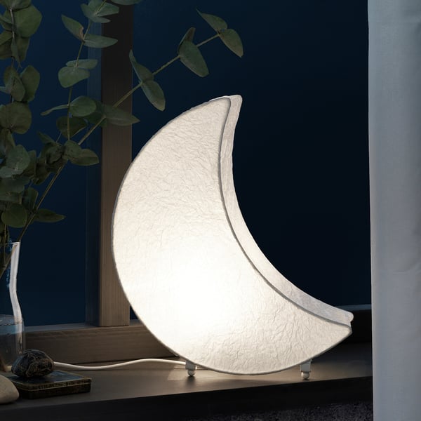 A stylish, half-moon shaped led table lamp, emitting soft, warm light, ideal for cosy ambience. Perfect for indoor use, it enhances festive decor.