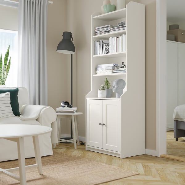 Modern living room with HAUGA bookshelf, couch, coffee table, and lamp.
