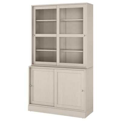 A light beige HAVSTA storage cabinet. It glass doors at the top and wooden cabinets below. The design is rustic with a brushed pine finish.