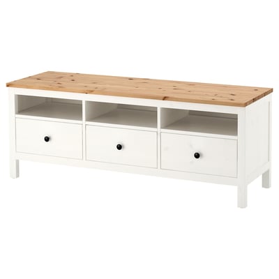 A white HEMNES storage unit made of solid pine with three drawers and an open shelf.