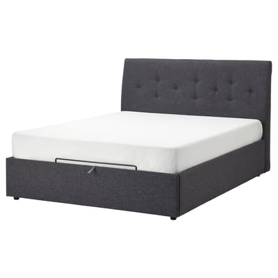 Dark grey upholstered bed with tufted headboard and white mattress.