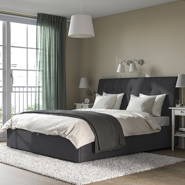 Modern bedroom with IDANÄS bed, under-bed storage, and large window framed by white curtains.