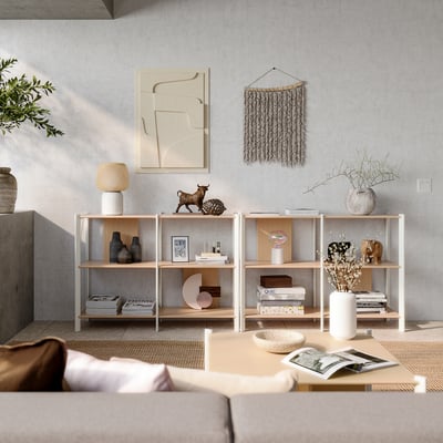 Minimalist living area with neutral tones, featuring wooden shelves with various decor items, a beige sofa, and abstract wall art.