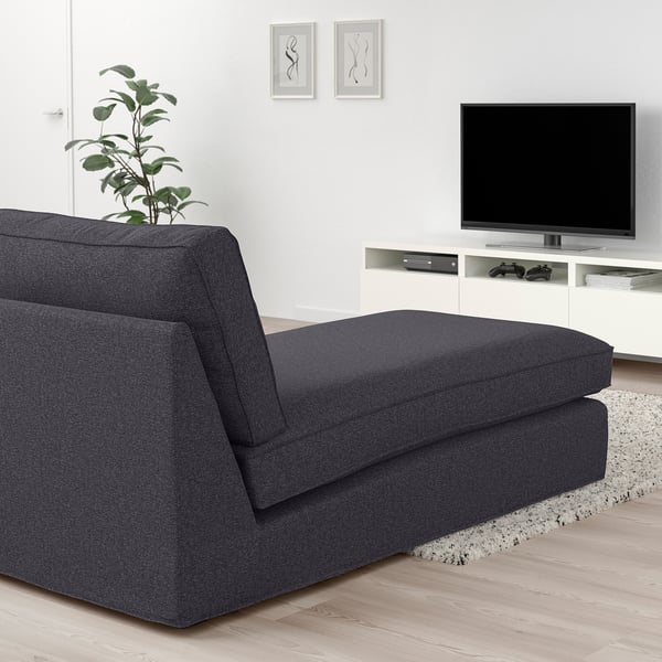 Modern living room with KIVIK grey chaise longue, tv, plant, and frames. Chic and cosy design.