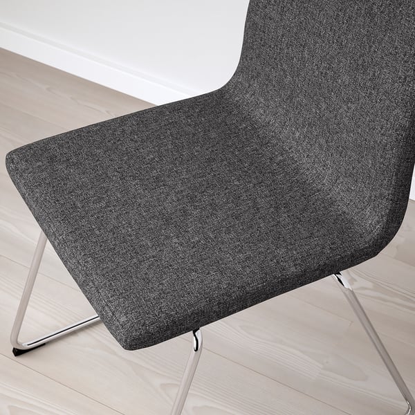 Modern, grey upholstered chair with sleek metal legs, offering comfort and style.