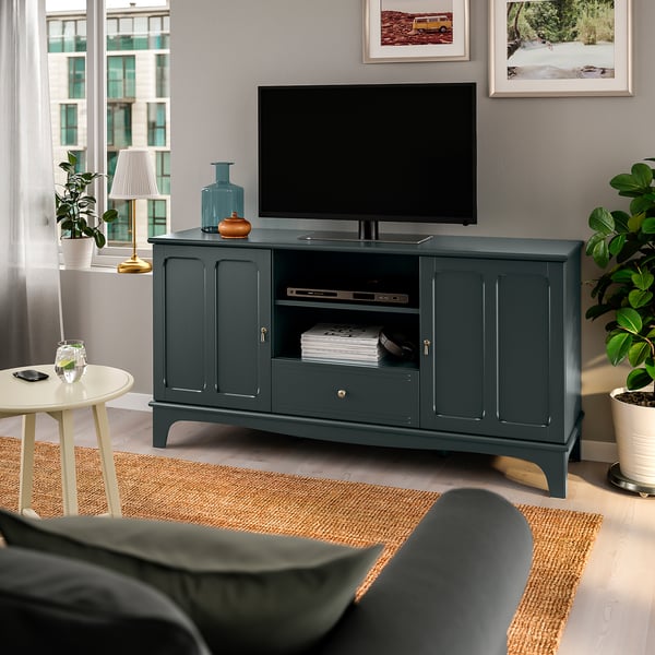 Green LOMMARP tv stand with flat screen, plants & side table. Spacious, classic design.