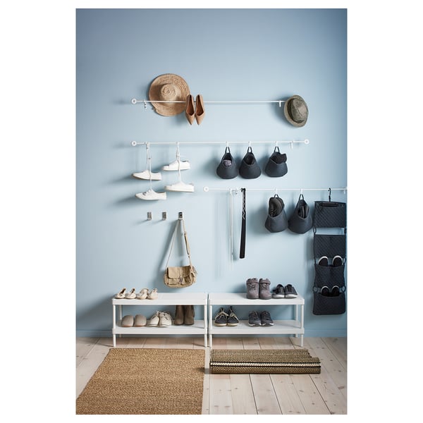 MACKAPÄR hallway organisation: shoe racks, hanging baskets, and bags on blue wall.