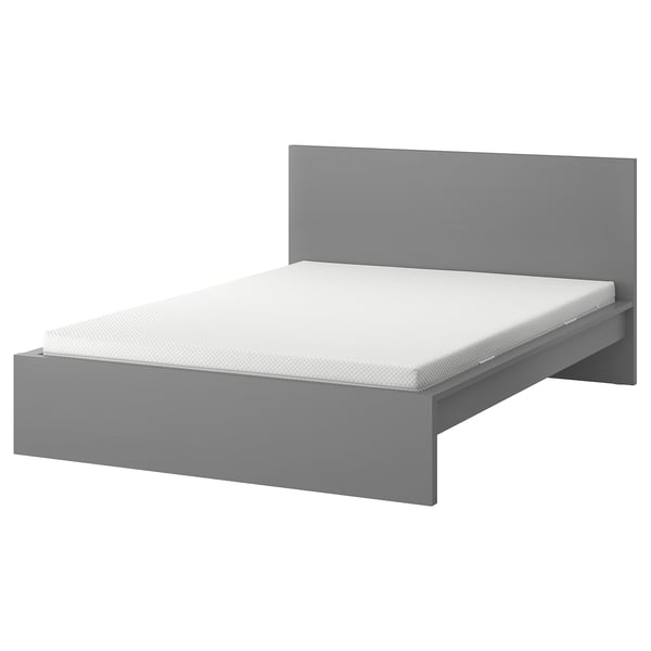 A MALM bed in grey, featuring a simple, modern design with a high headboard and adjustable bed sides.