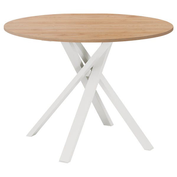 Modern round dining table with light wood top and white crossed metal legs. Elegant and sturdy design.