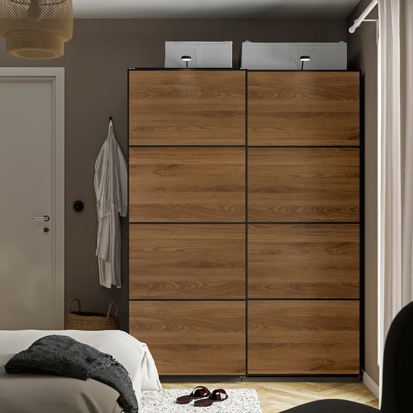 Brown MEHAMN wardrobe with 4 sliding panels in bedroom.