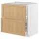 METOD kitchen unit with oak drawers and white base.