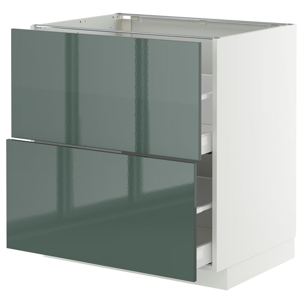 Modern kitchen cabinet, high-gloss grey-green with sleek drawers, white frame.