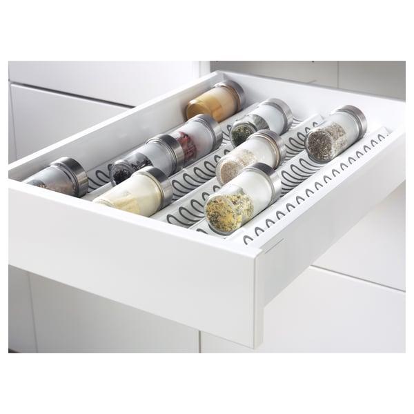 Open kitchen drawer with spices, clearly labelled and organised.