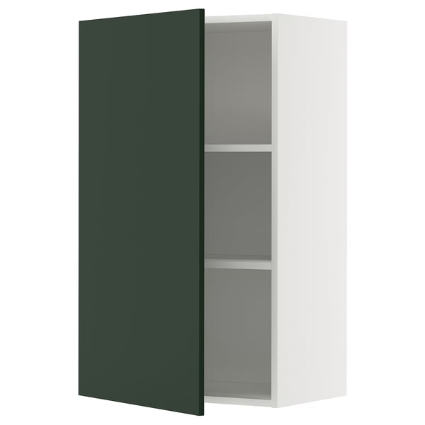 A METOD kitchen cabinet with a deep green havstorp door, featuring a white frame and adjustable shelves.