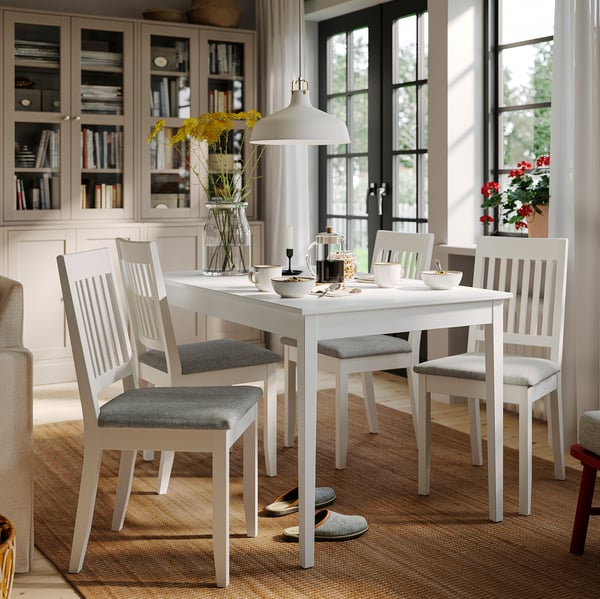 Modern white NÄSINGE dining set with square table and vertical chairs, perfect for small spaces.