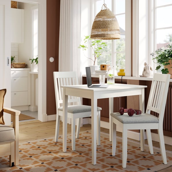 Compact white NÄSINGE dining table & chairs set in bright room.