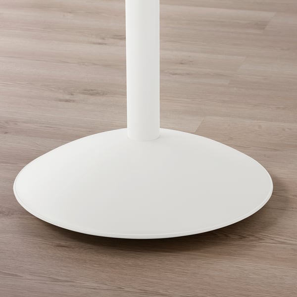 Modern, minimalist table base with flat circular top; sleek white finish; stable and minimalist design.
