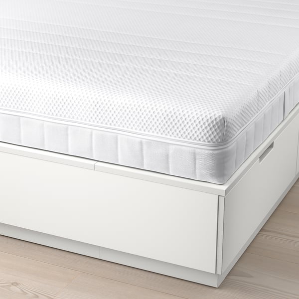 White bed with six drawers under mattress for storage.