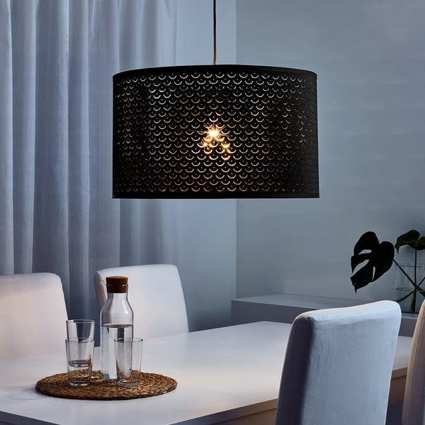 Modern dining with NYMÖ black pendant lamp, blue chairs, white table, curtains.