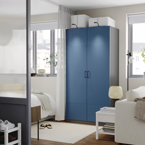 Grey-blue PAX wardrobe, sleek & spacious, ideal for small rooms.