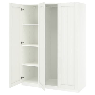 A white ikea PAX wardrobe with open doors revealing shelves. Simple, modern design.