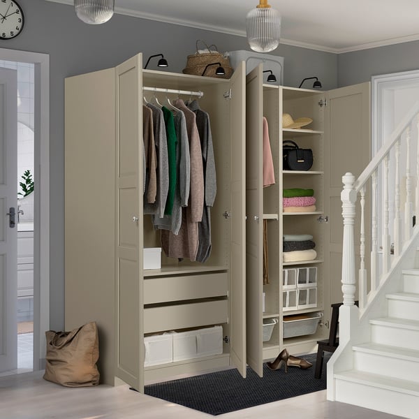 An open wardrobe unit displays clothes, accessories, and storage solutions in an organised entryway.