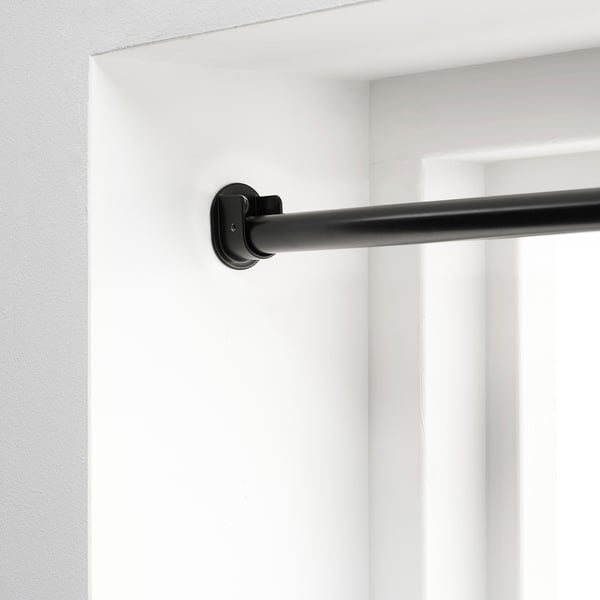 Black RÄCKA curtain rod, extendable, wall-mounted. Offers privacy with full coverage.