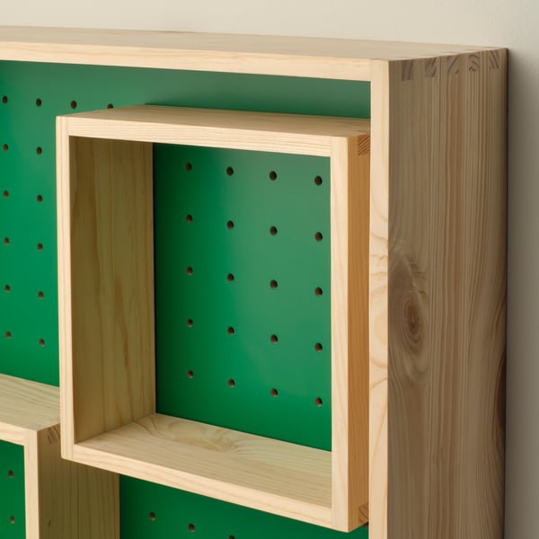 Modern wooden shelf with green pegboard, two movable shelves, sturdy and stylish.