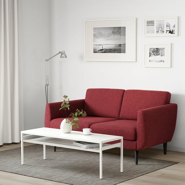 Modern living room with red SMEDSTORP sofa, coffee table, and lamp.