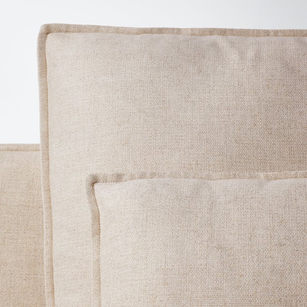 Neutral-toned, modern sofa with plush, inviting cushions. Upholstered in a soft, textured fabric with clean lines and high legs.