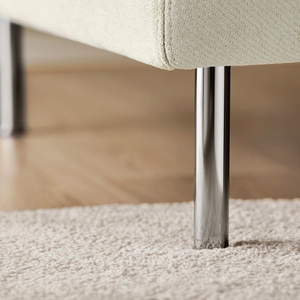 Modern sofa with sleek metal legs, plush cushions, on soft carpet.