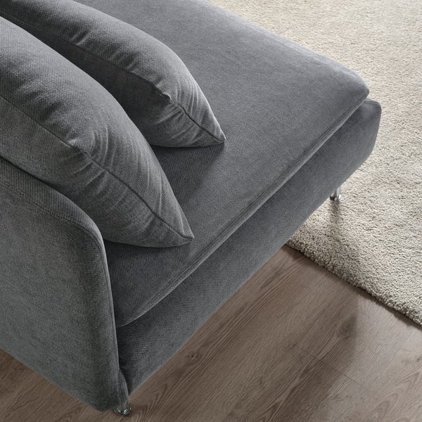Modern, grey, l-shaped couch on wood floor, plush cushions, thin metal legs.