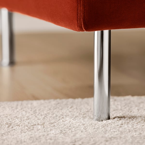 Close-up of a modern, stylish chair with polished metal legs and contemporary fabric. Excellent build quality and sleek design.