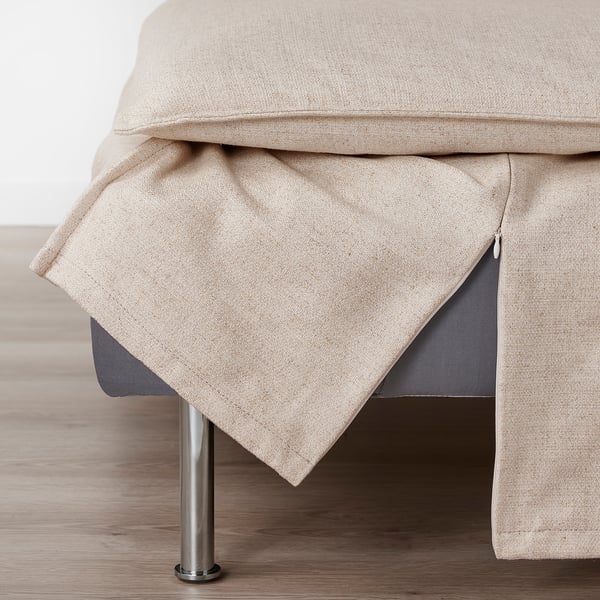 Beige sofa section with zip on light wood floor.