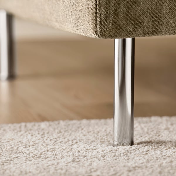 Modern chaise longue with sleek metal legs, comfortable fabric upholstery, on a plush rug