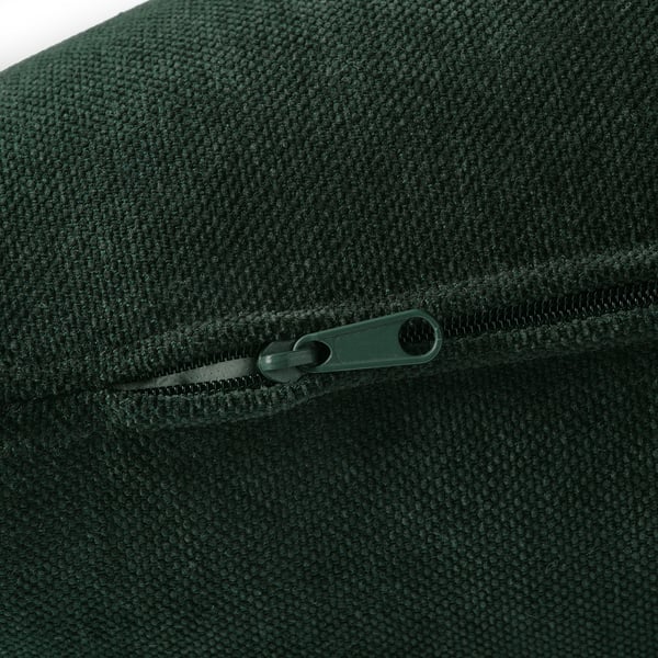Green textured fabric close-up with zip pull, showcasing quality detail.