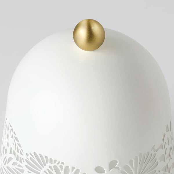 Elegant lamp with intricate floral base, gleaming gold sphere top, cast soft light.
