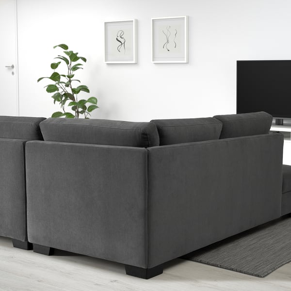 Modern dark grey SÖRVALLEN sofa, minimalist style, fits well in spacious living rooms.