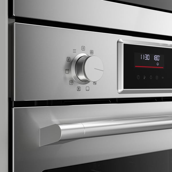 Modern stainless steel oven panel with central dial and digital display.