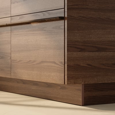 Dark brown wood cabinet drawer in close-up view.