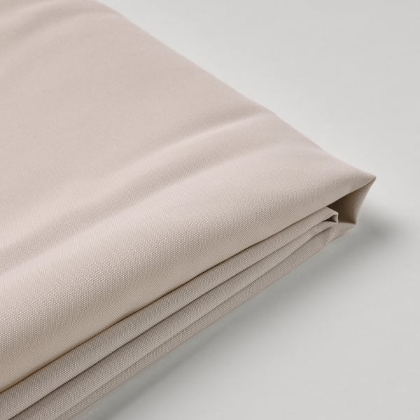 Folded beige fabric, neatly pressed, showcasing premium texture and quality.