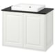 A white IKEA TÄNNFORSEN bathroom vanity with a sleek black countertop and a rectangular sink.