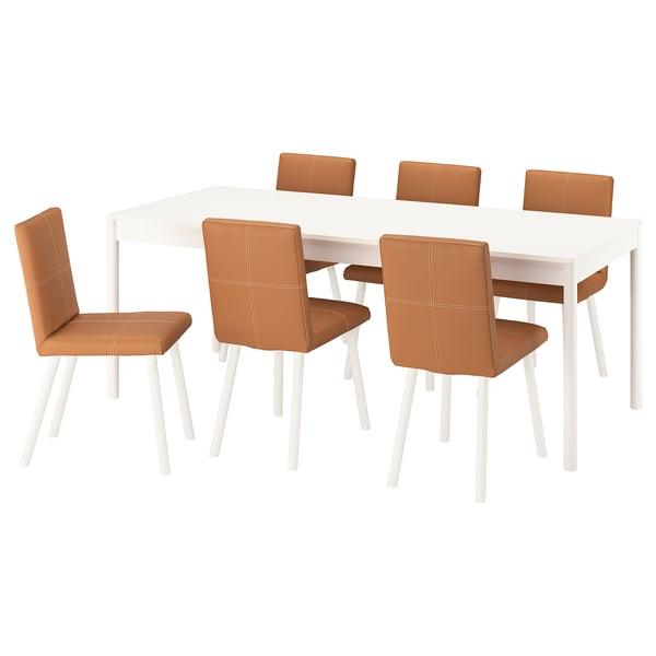 Dining set with white table, six tan upholstered chairs. Modern design, soft edges, sturdy legs.