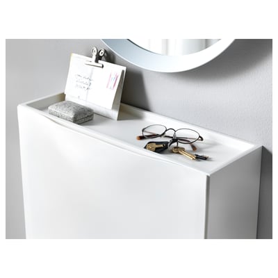 White TRONES cabinets hold items like keys and notes on top. The shallow design saves space and is ideal for small entrances.